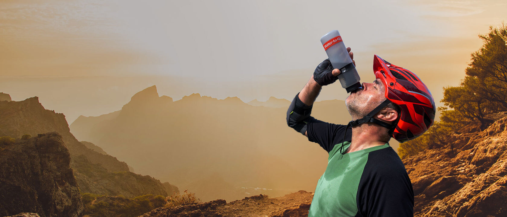 Mountain biker drinking from water filter bottle
