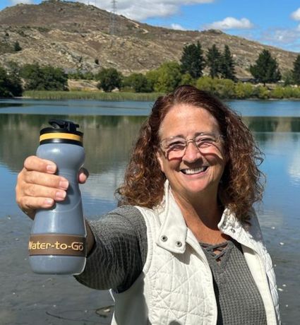 Woman_in_white_vest_holding_Water_to_Go_Bioplastic_water_filter_bottle