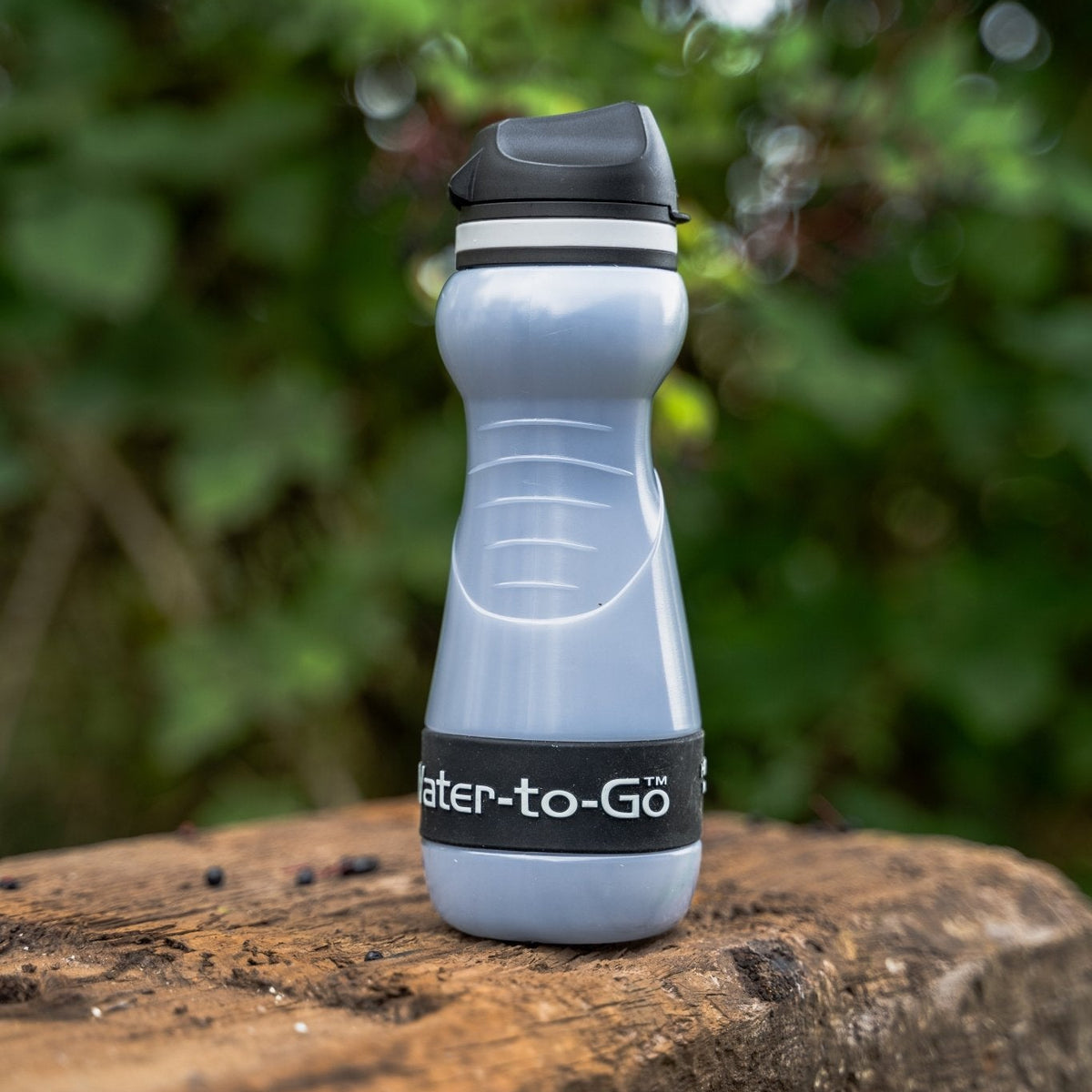 small water filtration bottle in woods