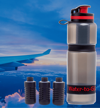 Water to Go water bottle with filter for travel with airplane wing in background
