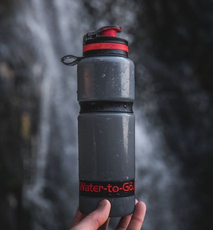 Beauty shot of hand holding Water to Go Active water filter bottle
