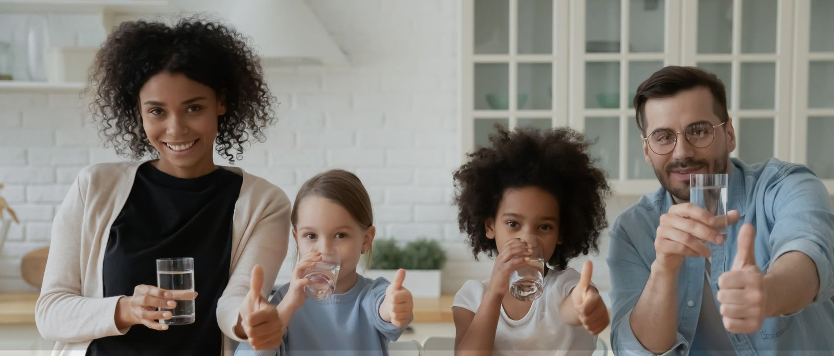 Interracial_family_drinking_water_and_giving_the_thumbs_up_