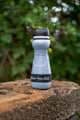 small water filtration bottle in woods