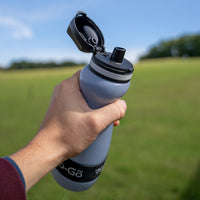 hand holding small water filtration bottle with lid open