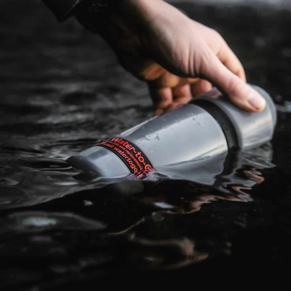 water_filtration_purifier_bottle_being filled at lake