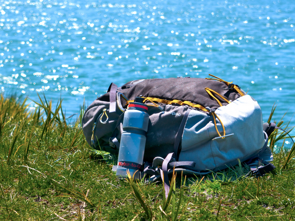 water purifier filtration bottle next to river